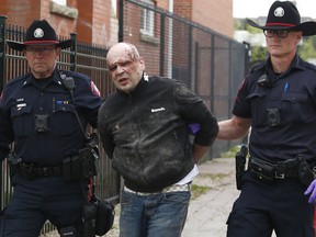 Members of the Calgary Police Auto Theft Team take prolific car thief Shane Schultz into custody along 13th Ave. SW. K9 assisted with the takedown. Schultz was treated by EMS at the scene. Charges are pending. Wednesday, May 15, 2019.