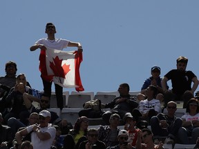 In this Thursday, May, 16, 2019 file photo, a supporter shows a Canadian flag during the match between Serbia's Novak Djokovic and Canada's Denis Shapovalov at the Italian Open, in Rome. (AP Photo/Alessandra Tarantino, File )