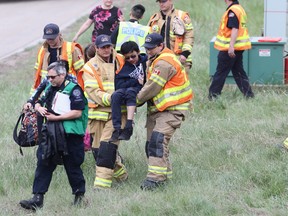 Edmonton firefighters and medical crews respond to the scene of a school bus crash on Whitemud Drive at 149 Street on Thursday, May 23, 2019.