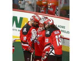 Roughnecks goalie Christian Del Bianco (C) is hugged by teammates Curtis Manning and Eli Salama (R) at the final buzzer during National Lacrosse League West Division final action between the Calgary Roughnecks and Colorado Mammoth in Calgary on Friday, May 10, 2019. Jim Wells/Postmedia