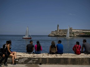People look at American sailboat racers during a regatta at the Malecon in Havana, Cuba, Saturday, May 4, 2019. .