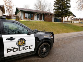 Police investigate a suspicious death at a home in the 4900 block of Rundlewood Road N.E. on Friday, May 3, 2019. A woman has since been charged with second-degree murder.