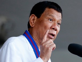 In this April 19, 2018, file photo, Philippine President Rodrigo Duterte addresses troops during the turnover-of-command ceremony for the new chief of the Philippine National Police General Oscar Albayalde succeeding General Ronald "Bato" Dela Rosa at Camp Crame in suburban Quezon city northeast of Manila, Philippines.