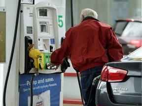 The UCP introduced a bill to scrap Alberta's carbon tax, imposed on fuel and home heating bills, as of May 30, 2019. A file photo shows a motorist fills his vehicle with gas at the Brookview Husky gas in 2018.