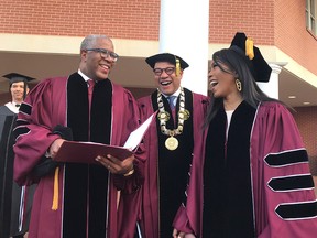 Robert F. Smith, left, laughs with David Thomas, centre, and actress Angela Bassett at Morehouse College on Sunday, May 19, 2019, in Atlanta.