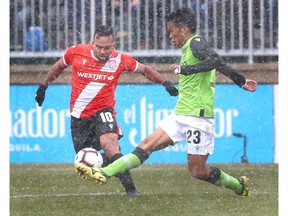 Cavalry FC Sergio Camargo (L) moves the ball upfield against York 9 FC Wataru Murofushi (R) during Canadian Premier League soccer action at Atco Field in Spruce Meadows in Calgary on  Saturday, May 4, 2019. Cavalry FC won their inaugual regular season game 2-1. Jim Wells/Postmedia
