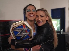Natalya Neidhart hugs new Smackdown Women's champion Bayley at Money In The Bank pay-per-view.