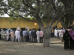 In this Thursday, April 11, 2019 file photo, Indians stand in a queue to cast their votes outside a polling station in Sawaal village, near Meerut, India. The final phase of India's marathon general election will be held on Sunday, May 19.