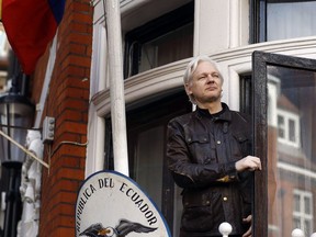 In this Friday, May 19, 2017 file photo, WikiLeaks founder Julian Assange looks out from the balcony while claiming political asylum at the Ecuadorian embassy in London.