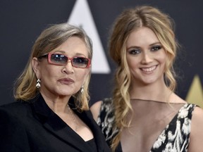 In this Nov. 14, 2015, file photo, Carrie Fisher, left, and her daughter Billie Catherine Lourd arrive at the Governors Awards at the Dolby Ballroom in Los Angeles.