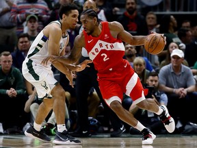 Kawhi Leonard of the Toronto Raptors moves around Malcolm Brogdon of the Milwaukee Bucks in the fourth quarter during Game Five of the Eastern Conference Finals on May 23, 2019 in Milwaukee, Wisconsin.