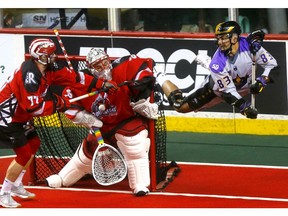 Calgary Roughnecks goalie, Christian Del Bianco makes a save on San Diego Seals, Austin Staats in National Lacrosse Leagure action at the Scotiabank Saddledome in Calgary on Saturday, March 30, 2019. Darren Makowichuk/Postmedia