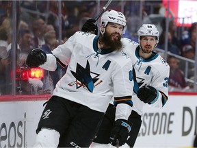San Jose Sharks defenceman Brent Burns, front, reacts after scoring a goal as center Logan Couture follows in the second period of Game 6 of an NHL hockey second-round playoff series against the Colorado Avalanche on Monday in Denver.