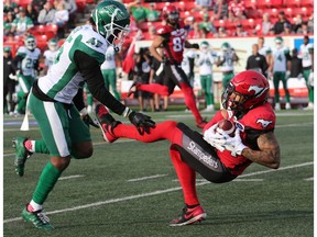 The Calgary Stampeders' Reggie Begleton catches a pass under pressure from the Saskatchewan Roughriders' Mike Edem  during pre-season CFL action at McMahon Stadium in Calgary on Friday May 31, 2019. Gavin Young/Postmedia
