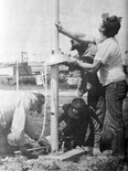 June 26, 1985 Vulcan Advocate file photo The 31 flags that will be raised this Dominion Day as part of the Fly a Flag project at Vulcan, had concrete bases poured last week and Monday the task of erecting poles began. Aluminum flag poles were taken from their crates, assembled with their caps, covers and interior lanyards, and finally, with three men on guy ropes, the first was raised above, at the town entrance, where 16 flags will be flown. Four bolts hold the pole secure and this pole was in an immediate wind test. “We’ve put up a couple of other similar poles and they’ll handle our winds”, said town worker Alf Daw. From the left are flag project chairman Pat Roe, town staff Henry Dyck and Daw, and town foreman Harold Lewis.