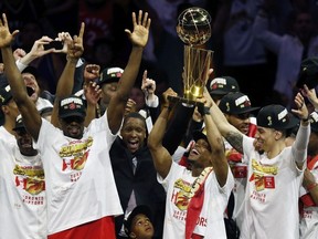 Kawhi Leonard #2 of the Toronto Raptors celebrates with the Larry O'Brien Championship Trophy after his team defeated the Golden State Warriors to win Game Six of the 2019 NBA Finals at ORACLE Arena on June 13, 2019 in Oakland, California.