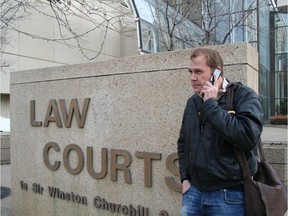 In a 2008 photo, Mark Cherrington takes a call from a young offender after a morning in youth court.