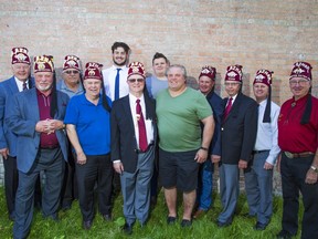 Shiners pose for a photo with high school football players Tariq Essa, rear left, and Nick Schmeiler as well as Spolumbos co-owner Tony Spoletini on Wednesday, June 12, 2019. The two local players were selected as the Canadian players in the annual Shriners East/West Bowl high school selects game in Montana. Gavin Young/Postmedia