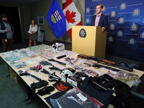 Inspector Monty Sparrow with the Calgary Police ServiceÕs Major Crimes Section talks about a major seizure by the Guns and Gangs Unit including multiple firearms, more than $275,000 in cash and $137,000 worth of drugs. Two people have since been charged with 84 offences. The service displayed the seized items on Thursday June 27, 2019. Gavin Young/Postmedia