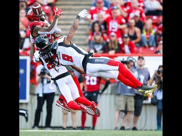 Calgary Stampeders Markeith Ambles is unable to make the catch in front of Ottawa Redblacks Sherrod Baltimore and Jonathan Rose during CFL football in Calgary on Saturday, June 15, 2019. Al Charest/Postmedia