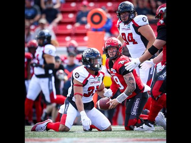 Calgary Stampeders quarterback Bo Levi Mitchell is upended by Kevin Brown the Ottawa Redblacks during CFL football in Calgary on Saturday, June 15, 2019. Al Charest/Postmedia
