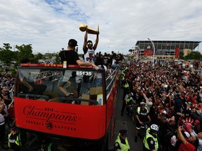 Toronto Raptors guard Kyle Lowry raises the Larry O'Brien NBA Championship Trophy during Raptors victory parade celebration in Toronto, Ontario, Canada, June 17, 2019.