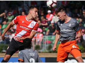 Cavalry FC's Dominick Zator and Forge FC's Daniel Krutzen go up to head the ball during Canadian Premier League soccer action at Spruce Meadows on Saturday, June 22, 2019. Forge won the game 1-0. Gavin Young/Postmedia