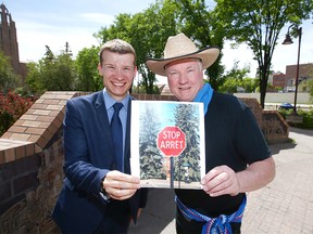 City of Calgary Coun Jeromy Farkas (L) and Rob Lennard pose at Rouleauville Square near 17 Ave and 1 St SW in Calgary on  Wednesday, June 12, 2019. Lennard and others are proposiing to make a small number of stop signs bilingual and it will be privately funded. Jim Wells/Postmedia