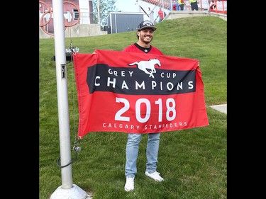 Former Calgary Stampeder all-star linebacker Alex Singleton raises the Grey Cup Championshop banner before CFL action between the Ottawa Redblacks and the Calgary Stampeders in Calgary on Saturday, June 15, 2019. Jim Wells/Postmedia