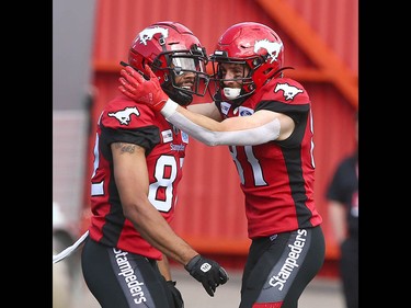Stamps Juwan Brescacin (L) and Michael Klukas (R) celebrate Brescacin's TD in the first quarter during CFL action between the Ottawa Redblacks and the Calgary Stampeders in Calgary on Saturday, June 15, 2019. Jim Wells/Postmedia