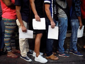 Cuban migrants wait outside the Mexican Commission for Refugee Assistance (COMAR) in Tapachula, Mexico, on Friday, June 14, 2019.