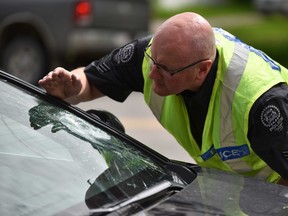 Calgary police survey a vehicle that struck a teenage girl on Tuesday, June 11, 2018. She suffered multiple serious injuries.