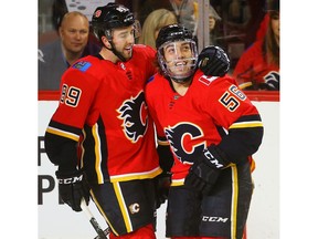 Calgary Flames Ryan Lomberg celebrates with teammate Alan Quine  (left) after scoring against the Winnipeg Jets in NHL pre-season hockey at the Scotiabank Saddledome in Calgary on Monday, September 24, 2018. Al Charest/Postmedia