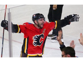 The Calgary Flames captain Mark Giordano celebrates with teammates after an overtime defeat of the Philadelphia Flyers 6-3 in NHL action at the Scotiabank Saddledome in Calgary on Wednesday December 12, 2018.  Gavin Young/Postmedia
