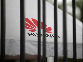 A Huawei logo is seen outside the fence at its headquarters in Shenzhen, Guangdong province, China May 29, 2019.