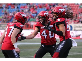 Calgary StampedersÕ Fraser Sopek, Nate Holley, and Jaman Gilbert celebrate a turnover during pre-season CFL action against the Saskatchewan Roughriders at McMahon Stadium in Calgary on Friday May 31, 2019.