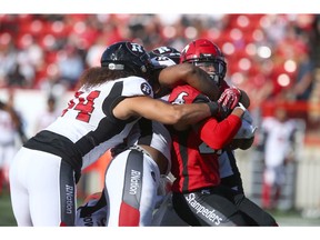Stampeder RB Don Jackson is wrapped up by Ottawa Redblacks' defenders during CFL action between the Ottawa Redblacks and the Calgary Stampeders in Calgary on Saturday, June 15, 2019. Jim Wells/Postmedia