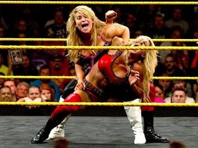 Natalya Neidhart locks Charlotte Flair in an abdominal stretch in a match for the NXT Women's Championship at the first NXT Takeover in 2014. (WWE Photo)