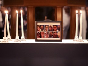 A photograph of the victims of a mass shooting is surrounded by 12 candles during a memorial service at Piney Grove Baptist Church June 2, 2019 in Virginia Beach, Va.