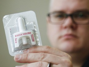 A police officer holds a naloxone nasal spray device in Belleville, Ont. Narcan is being distributed to Boys and Girls Clubs of Canada locations.