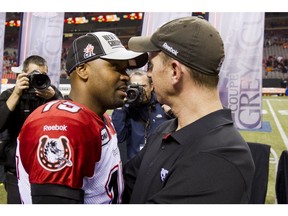 Calgary Stampeders QBs coach Dave Dickenson congratulates Kevin Glenn on the victory at the end of the CFL Western Division Final at BC Place in Vancouver in this photo from Nov. 18, 2012. Postmedia file photo.