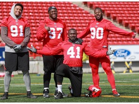 Calgary Stampeders defensive linemen Mike Rose, Derek Wiggan, Cordarro Law and Folarin Orimolade ham it up for the camera during CFL training camp on Monday, May 20, 2019. Al Charest/Postmedia