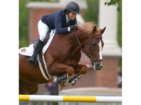 USA's Beezie Madden rides Darry Lou to victory in a jump-off in the ATB Financial Cup at Spruce Meadows in Calgary on Thursday. Photo by Jim Wells/Postmedia.