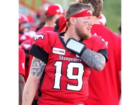 Stamps quarterback Bo Levi Mitchell is seen on the sidelines favouring his left shoulder during the 2nd half of action as Calgary Stampeders beat B.C. Lions 36-32 at McMahon Stadium during week 3 of CFL action. Saturday. Photo by Brendan Miller/Postmedia.