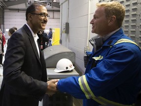 Natural Resources Minister Amarjeet Sohi (left) talks with workers at the Trans Mountain Corporation's Edmonton Terminal, Tuesday June 18, 2019. During the visit Sohi spoke about the recent approval of the Trans Mountain Expansion pipeline project. Photo by David Bloom
