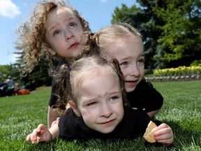 Triplets, L-R, Bayleigh, Kyle and Aryana Diprose,3, were among 16 family's, 14 with triplets and 2 with quadruplets who met up at the Calgary Zoo for the day on Saturday, June 22, 2019. Darren Makowichuk/Postmedia