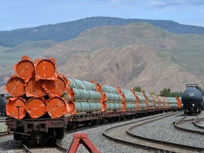 Steel pipe to be used in the oil pipeline of Kinder Morgan Canada's Trans Mountain expansion project sit on rail cars at a stockpile site in Kamloops, B.C., on May 29, 2018.