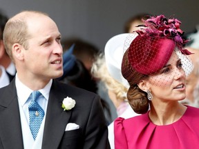 Prince William and Kate, Duchess of Cambridge, look up at the Royal Standard flying from the round tower following the wedding of Princess Eugenie of York and Jack Brooksbank in St George's Chapel, Windsor Castle, near London, on Oct. 12, 2018.