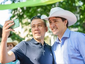 Prime Minister Justin Trudeau takes a selfie with an attendant at a community Stampede Breakfast at Sunalta in Calgary on Saturday, July 13, 2019. Azin Ghaffari/Postmedia Calgary