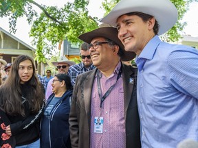 Prime Minister Justin Trudeau poses with Mayor Naheed Nenshi during the Calgary Stampede on July 13, 2019.